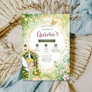 May include: A rectangular birthday invitation card featuring a watercolour illustration of a fairy with blonde hair and green clothing. The design includes a gold geometric frame, string lights, flowers, and text reading Join Us For A Celebrating Aurora's 5th Birthday, with event details for June 15, 2025, at Pixie Hollow Garden.