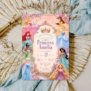 May include: A rectangular birthday invitation card featuring illustrations of eight princesses in colorful gowns surrounding a central gold crown. The text reads: You're invited to a magical birthday Princess Amelia is turning 3! with placeholders for date, time, venue, address, RSVP, and phone number.