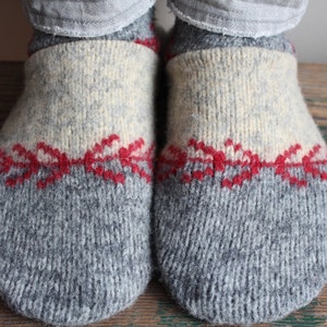 May include: A pair of gray wool slippers with a white and red knit pattern.