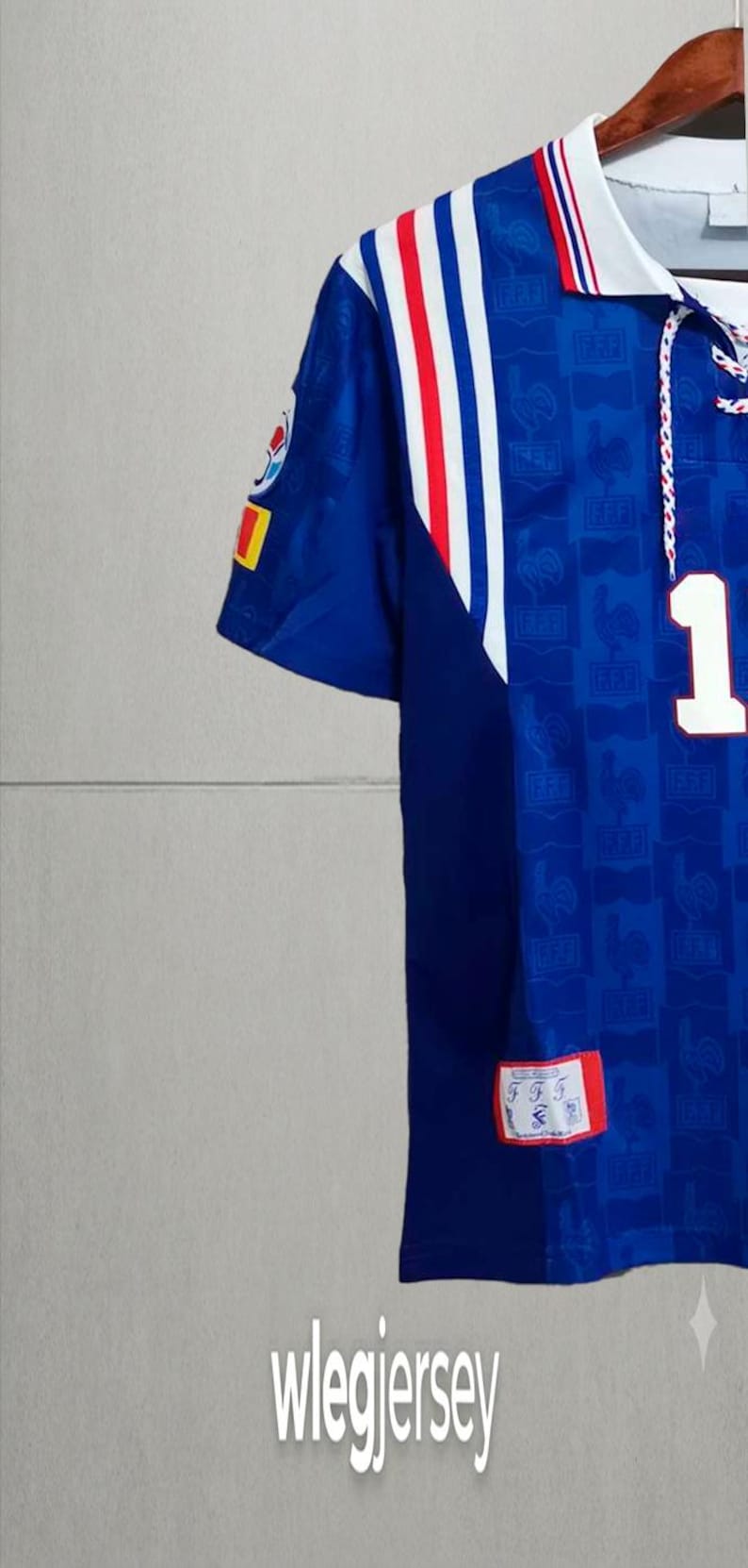 May include: A blue soccer jersey featuring a white collar with red and blue stripes, a white number 1 on the chest, and a repeating FFF logo pattern. The sleeve has a circular emblem and a small rectangular patch with the text FFF and a rooster icon.