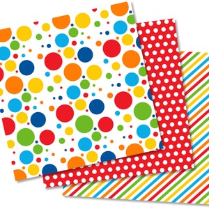 May include: Three sheets of colorful patterned paper. The first sheet has a white background with large red, orange, yellow, green, and blue polka dots. The second sheet has a red background with white polka dots. The third sheet has a red, orange, yellow, and green striped pattern.