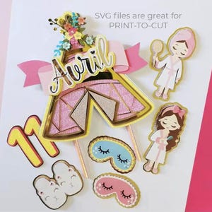 May include: A pink and gold printable cake topper set with a tent, flowers, a girl in a robe, and the name "Avril" on a pink ribbon. The set also includes a number 11, two pairs of eye masks, and a pair of slippers.