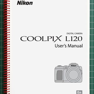 May include: A white Nikon Coolpix L120 digital camera user's manual with a red spiral binding. The cover features the Nikon logo, the text COOLPIX L120 User's Manual, a line drawing of the camera, and a small square box containing the letters En.