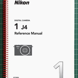 May include: A white spiral-bound reference manual for the Nikon 1 J4 digital camera. The cover features the Nikon logo, the text "DIGITAL CAMERA 1 J4 Reference Manual", a small graphic of the camera, a large number 1, and an "En" language indicator.