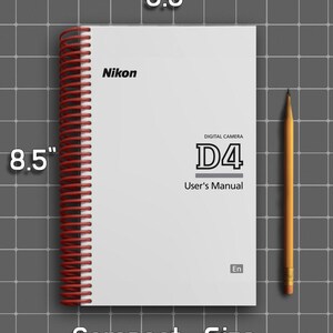 May include: A white Nikon D4 digital camera user's manual with a red spiral binding. The cover features the text Nikon, Digital Camera D4, User's Manual, and En. The manual measures 5.5 inches by 8.5 inches and is shown next to a yellow pencil.