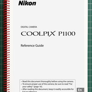 May include: A white Nikon Coolpix P1100 digital camera reference guide with a red spiral binding. The cover features black text including the brand name, model number, and instructions to read the document thoroughly before using the camera.