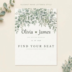May include: A white wedding seating plan sign featuring a watercolour eucalyptus leaf arch at the top. The text reads ELEGANT HAND LETTERED STYLE, Olivia and James are getting married, 14.06.2026, FIND YOUR SEAT, and A PRINTABLE WEDDING SEATING PLAN.