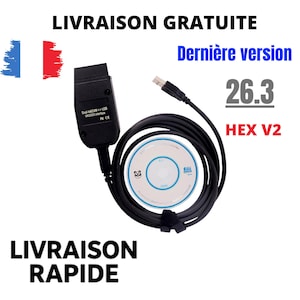 Peut inclure: Un câble d'interface de diagnostic noir avec un connecteur USB et un module rectangulaire marqué Dual-K&CAN USB VAG/ISO-interface. L'ensemble comprend un disque logiciel blanc circulaire avec un logo panda et le texte 26.3 HEX V2.
