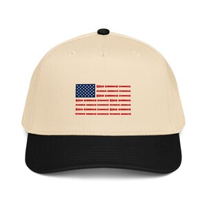 May include: A beige baseball cap with a black brim and a top button. The front features a graphic of the American flag, where the blue canton contains white stars and the red stripes are composed of small, repeating red flashlight icons.