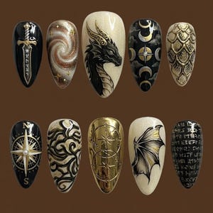 May include: A set of ten almond-shaped press-on nails featuring fantasy-themed designs. The collection includes black and gold motifs such as a sword, a galaxy swirl, a dragon head, moon phases, dragon scales, a compass, abstract swirls, geometric circles, a dragon wing, and runic text.