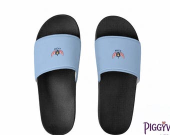 Puede incluir: Un par de sandalias tipo chancla negras con tiras de color azul claro. Cada tira muestra un pequeño gráfico de un escudo con alas y el texto PVHQ. Las plantillas son negras y tienen una superficie texturizada.