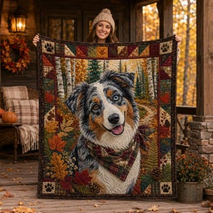 May include: A rectangular quilt featuring a central portrait of a blue merle Australian Shepherd dog wearing a plaid bandana. The dog is surrounded by an autumn forest scene with birch trees and colorful leaves. The border has a geometric pattern.
