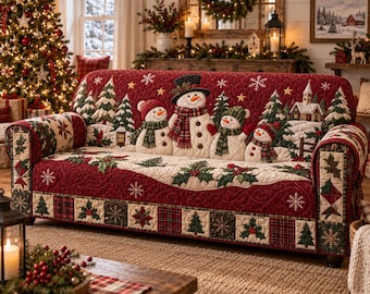 May include: A quilted sofa cover in deep red featuring a festive Christmas scene with four snowmen wearing scarves and hats, surrounded by evergreen trees, holly leaves, and a small house. The border displays a plaid and snowflake pattern.