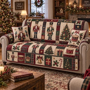 May include: A quilted sofa cover featuring a festive Christmas theme with nutcrackers, decorated pine trees, drums, bells, gift boxes, and candy canes in a patchwork pattern of cream, red, and dark green, including two matching throw pillows.