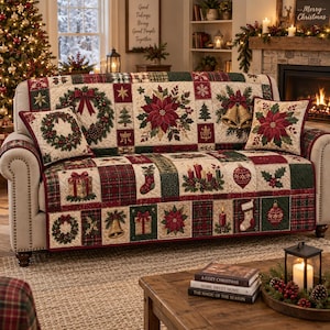 May include: A beige sofa cover featuring a patchwork design with Christmas motifs including poinsettias, wreaths, bells, stockings, candles, and gifts in red, green, and gold. Two matching square throw pillows are included on the sofa.