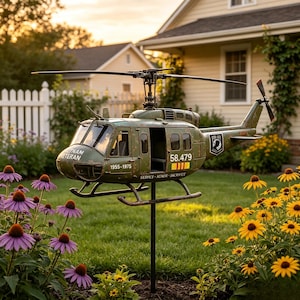 May include: A green metal helicopter garden spinner featuring the text VIETNAM VETERAN, 1955-1975, 58.479, and SERVICE HONOR SACRIFICE. The helicopter has a weathered finish, a main rotor, a tail rotor, and is mounted on a black metal pole.