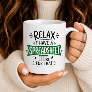 May include: A white ceramic mug featuring black and green text that reads RELAX I HAVE A SPREADSHEET FOR THAT, with a green banner graphic behind the word SPREADSHEET and a small icon of a spreadsheet grid with a green checkmark underneath.