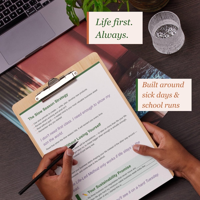 May include: A wooden clipboard holding a printed document with the text The Slow Season Strategy, I don't need first class, Without Losing Yourself, and Your Sustainability Promise. A black pen rests on the paper, with text overlays Life first. Always. and Built around sick days & school runs.