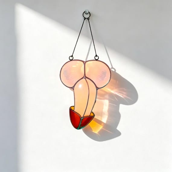 Actual handmade leaded stained glass with adult-humor imagery — real craft skill meets cheeky novelty in a genuinely one-of-a-kind sun-catcher.