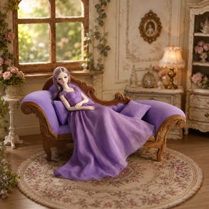 May include: A ball-jointed doll with long lavender hair wearing a floor-length, off-the-shoulder lavender gown. The doll is reclining on a miniature wooden chaise lounge upholstered in purple fabric, featuring carved scrollwork details on the frame.