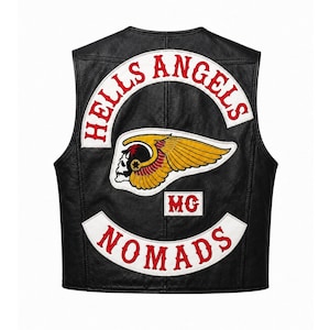 May include: A black leather waistcoat featuring a large embroidered patch on the back. The patch displays the text HELLS ANGELS in red on a white arc, a winged skull emblem in yellow, red, and white, and the text NOMADS in red on a white arc.