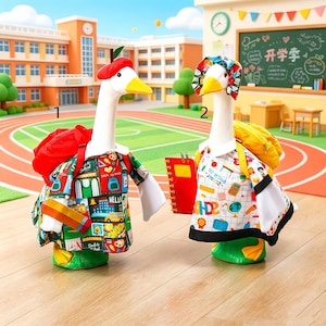 May include: Two plush goose figures dressed for school. The first wears a red beret, a red backpack, and a green shirt with school-themed graphics. The second wears a colorful patterned bonnet, a yellow backpack, and a white shirt with school icons.