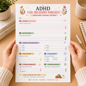 May include: A white ADHD task breakdown worksheet printed on paper with colourful autumn leaf illustrations. The document features sections for big tasks, importance, small steps, time estimates, roadblocks, and rewards, with text in English.