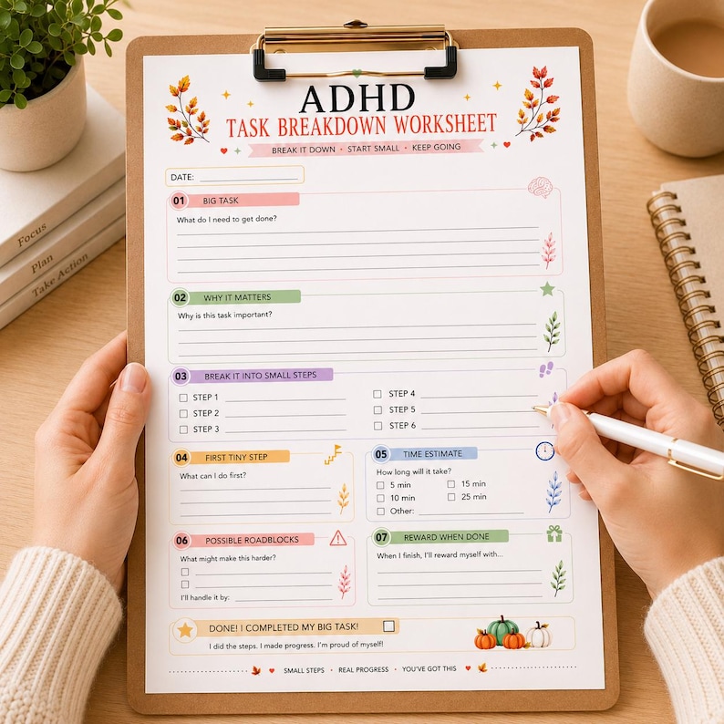 May include: An ADHD task breakdown worksheet on a brown clipboard with a gold clip. The paper features sections for big tasks, importance, small steps, time estimates, and rewards, decorated with autumn leaves and pumpkins, with text in English.