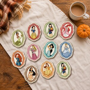 May include: A collection of eleven embroidered patches, each featuring a different female character within a scalloped, striped oval frame. The patches display various colours including red, green, blue, pink, and orange, showcasing detailed thread work.