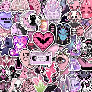May include: A collection of assorted vinyl stickers featuring pastel pink and purple themes. Designs include a bat heart, a cassette tape labeled 'HORROR MOVIE NIGHT', a skull with knives, a strawberry with an eye, and various cute creatures.