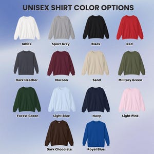 May include: A color chart titled UNISEX SHIRT COLOR OPTIONS displaying thirteen crewneck sweatshirts in white, sport grey, black, red, dark heather, maroon, sand, military green, forest green, light blue, navy, light pink, dark chocolate, and royal blue.