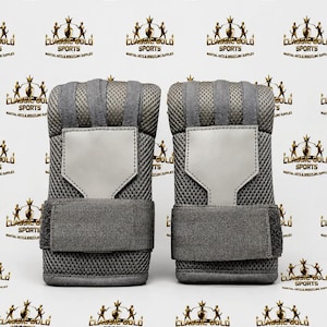 May include: A pair of grey mesh hand wraps featuring a solid grey rectangular patch on the back of the hand and a wide adjustable hook-and-loop strap at the wrist. The fabric has a textured, breathable grid pattern throughout the design.