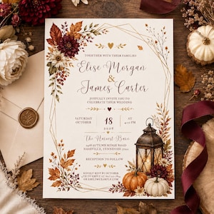 May include: A wedding invitation card featuring a gold geometric frame, autumn leaves, and dark red flowers. Text includes names Elise Morgan and James Carter, date October 18, 2026, and location The Harvest Barn, 2468 Autumn Ridge Road, Nashville, Tennessee.
