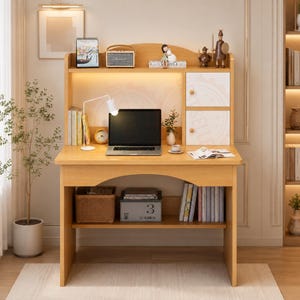 May include: A light wood desk with an integrated hutch featuring a white two-door cabinet, an open shelf, and a lower storage shelf. The desk includes a laptop, a white desk lamp, books, a small clock, and decorative figurines on the upper shelf.