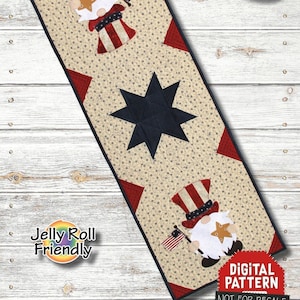 Puede incluir: Un patrón de costura digital para un camino de mesa de gnomo patriótico. El patrón presenta un gnomo rojo, blanco y azul con una estrella en su sombrero y una estrella en el centro del camino de mesa. El patrón mide 31,75 cm por 91,44 cm y está etiquetado como "Jelly Roll Friendly".