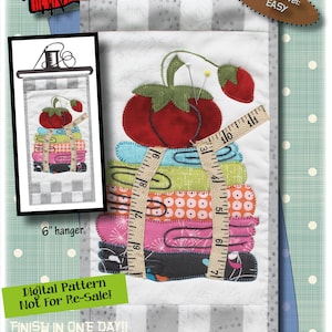 May include: Sew Necessary quilt pattern featuring a stack of fabric scraps, a measuring tape, and a strawberry with sewing pins. The pattern is 6 inches by 12 inches and is labeled "Easy" skill level. The text "Digital Pattern Not For Re-Sale!" is also included.