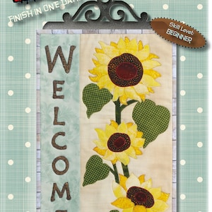 May include: A digital pattern for a sunflower welcome sign, featuring three sunflowers with green leaves and the word "WELCOME" in brown letters. The pattern is 10 inches by 16 inches and is labeled as a beginner skill level. The text "Digital Pattern Not For Re-Sale!" is also included.