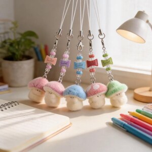 May include: Five hanging charms featuring fuzzy, plush mushroom figures in pink, blue, and green. Each charm includes a silver-toned metal clasp, clear beads, and a small, rectangular candy-shaped bead with the word Sweet printed on the surface.