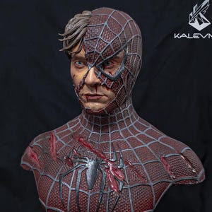 May include: A detailed bust of a character with a half-exposed human face and a half-masked red and black spider-patterned suit. The chest features a black spider emblem and battle damage. Mechanical tentacles extend from the base, which displays the text KALEVNIX.