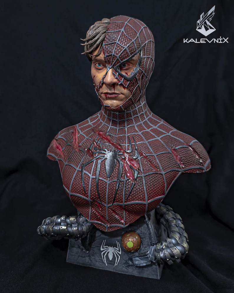 May include: A detailed bust of a character with a half-exposed human face and a half-masked red and black spider-patterned suit. The chest features a black spider emblem and battle damage. Mechanical tentacles extend from the base, which displays the text KALEVNIX.