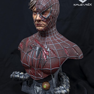 May include: A detailed bust of a character with a half-exposed human face and a half-masked red and black spider-patterned suit. The chest features battle damage, and the base includes mechanical tentacles and the text KALEVNIX in the corner.