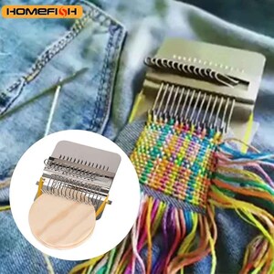 May include: A metal darning loom tool featuring a circular wooden base and a series of vertical metal hooks. The device is shown in use, creating a colorful woven patch with multi-colored threads on a piece of blue denim fabric.