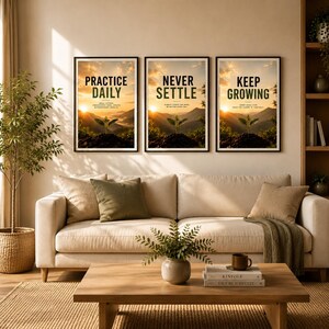 May include: Three framed wall art prints featuring a sunrise over mountains and a small sprout. The text reads PRACTICE DAILY, NEVER SETTLE, and KEEP GROWING. The prints are displayed in black frames above a beige sofa with cushions and a wooden table.