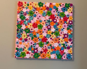Unique handmade artwork featuring hundreds of crafted clay flowers on either a blue or pink canvas. 30cm x 30cm