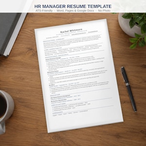 May include: A white paper resume template for an HR Manager position, featuring sections for professional summary, core competencies, experience, education, and certifications, with black text on a white background, placed on a wooden desk.