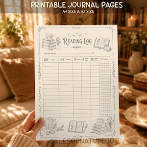May include: A printable reading log journal page featuring black line art on a white background. The header reads Reading Log, with illustrations of stacked books, a teacup, and an open book. It includes columns for title, author, pages, dates, and heart ratings.