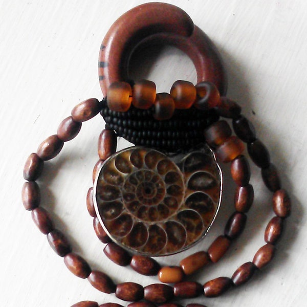 0 gauge sawa wood ear weights with ammonite fossils, thread wrapped with woven glass and wood beads, trade beads, for stretched ears