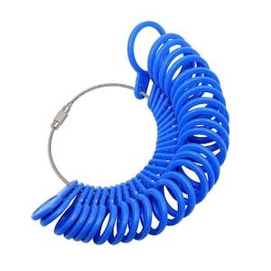 May include: A set of blue plastic ring sizers arranged in a graduated arc on a flexible metal cable. Each individual ring features a small tab with embossed numerical markings to indicate specific sizes for measuring finger circumference accurately.