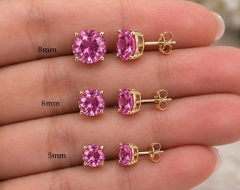 May include: Three pairs of round-cut pink gemstone stud earrings set in gold metal prongs with butterfly backings. The earrings are labelled with sizes 8mm, 6mm, and 5mm, showing the varying diameters of the stones in a clear, side-by-side comparison.