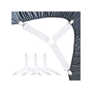 May include: A set of white elastic bed sheet fasteners with metal clips. One fastener is attached to the corner of a dark gray fitted sheet, while three additional fasteners are displayed separately below on a plain white background.